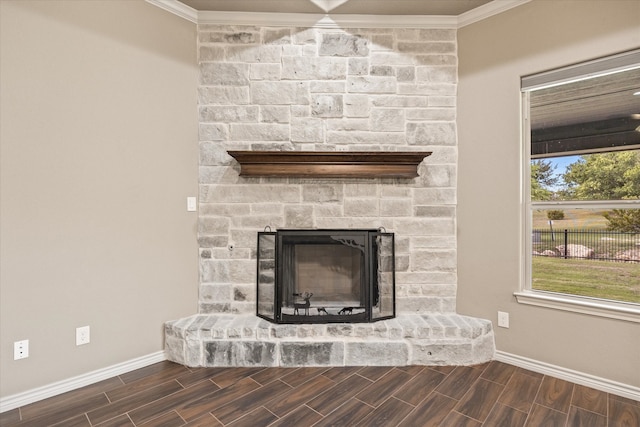 details featuring crown molding, wood-type flooring, and a stone fireplace