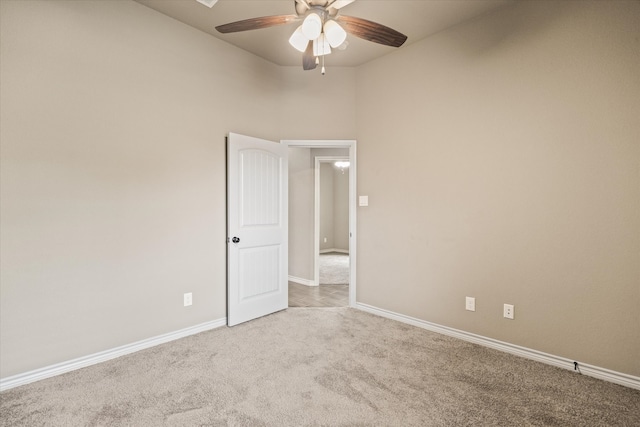 spare room featuring ceiling fan and light carpet