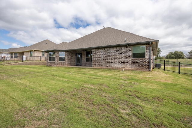 rear view of house with a lawn