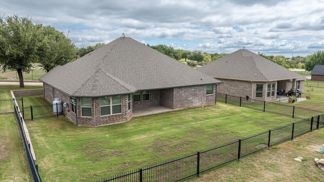 back of property featuring a yard and a patio area