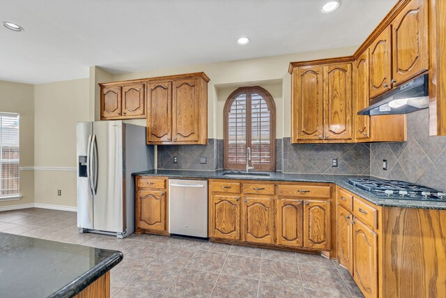 kitchen featuring tasteful backsplash, light tile patterned flooring, stainless steel appliances, and sink