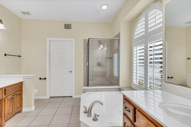 full bathroom featuring separate shower and tub, vanity, tile patterned flooring, and toilet