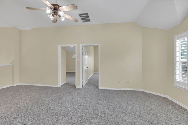 unfurnished bedroom featuring vaulted ceiling and light colored carpet