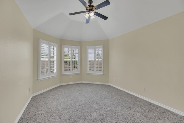 unfurnished room with plenty of natural light, vaulted ceiling, ceiling fan, and carpet floors