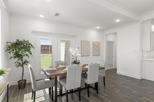 dining space with crown molding and dark hardwood / wood-style flooring