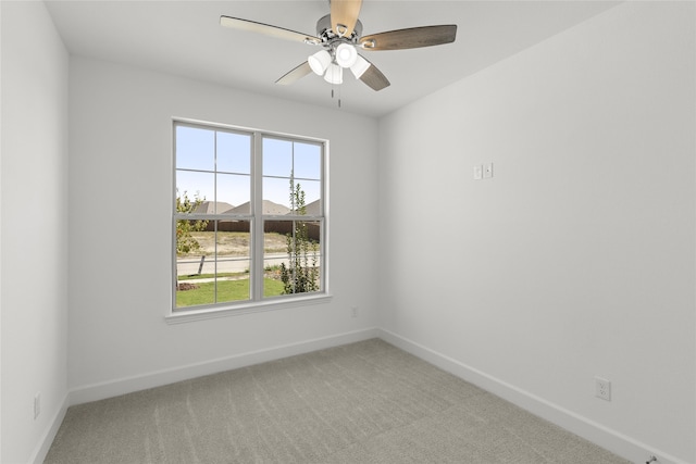 carpeted spare room with ceiling fan and plenty of natural light