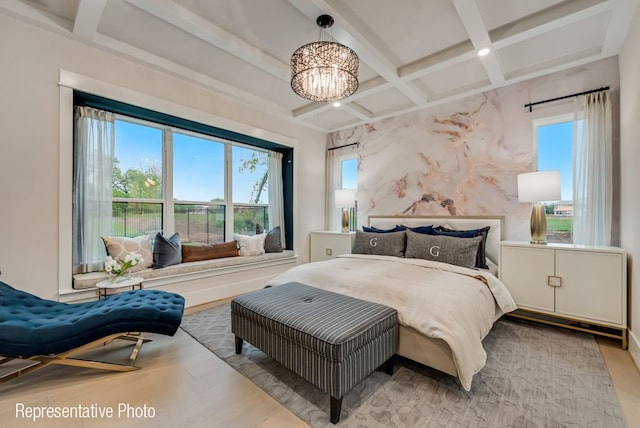 bedroom featuring a chandelier, beamed ceiling, light hardwood / wood-style floors, and coffered ceiling