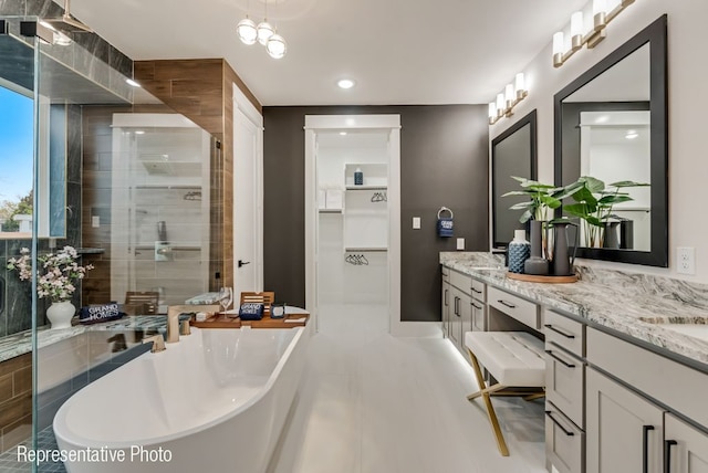 bathroom with vanity and shower with separate bathtub