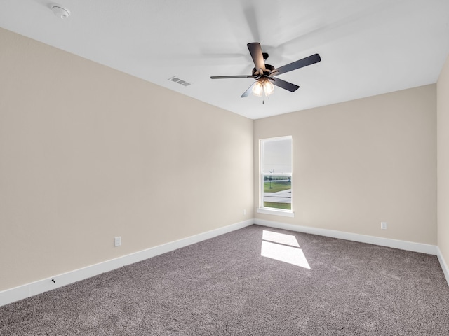 carpeted spare room featuring ceiling fan