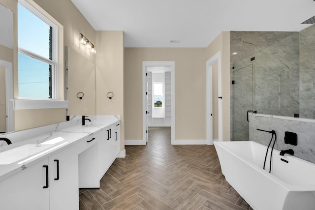 bathroom featuring vanity, parquet floors, and plus walk in shower