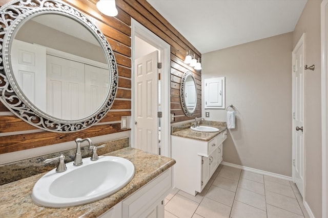 bathroom featuring tile patterned floors, vanity, and wooden walls