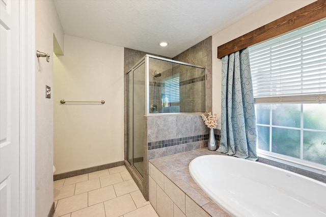 bathroom featuring tile patterned flooring, toilet, and shower with separate bathtub