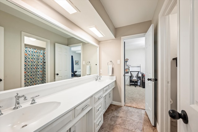 bathroom featuring tile patterned flooring and vanity