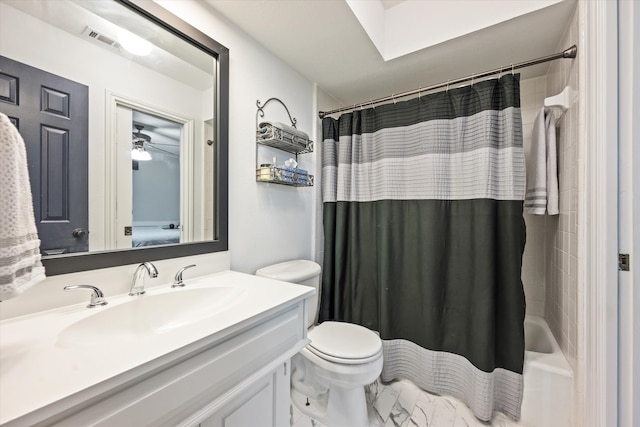 full bathroom with vanity, ceiling fan, toilet, and shower / bath combo