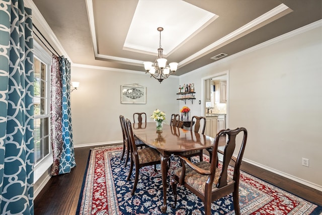 dining space featuring a raised ceiling, dark hardwood / wood-style flooring, and ornamental molding