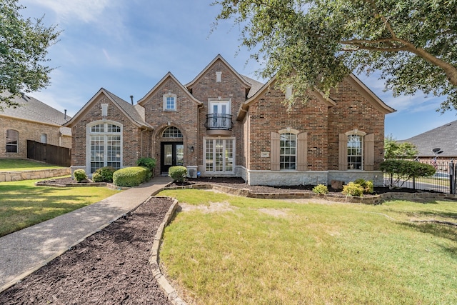 front facade with french doors and a front yard