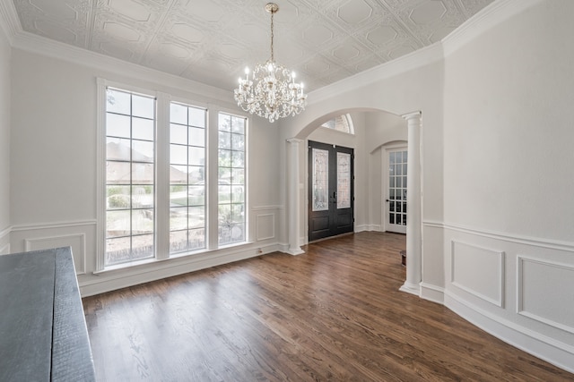 foyer entrance featuring dark hardwood / wood-style flooring, a notable chandelier, and plenty of natural light