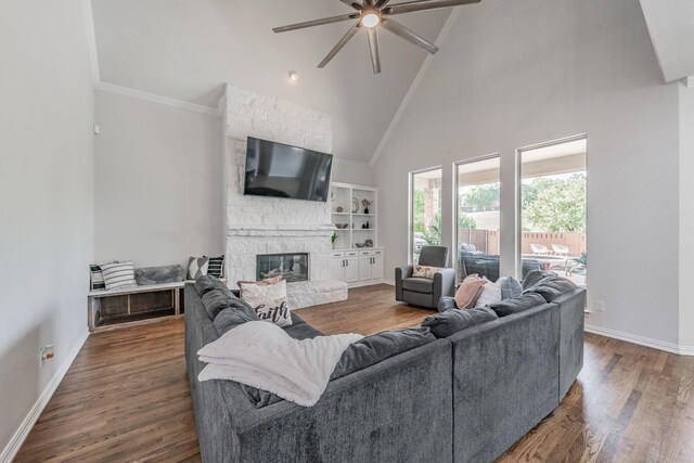 living room featuring a fireplace, high vaulted ceiling, ceiling fan, and dark hardwood / wood-style flooring