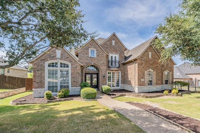 view of front facade with a front yard and french doors