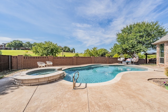 view of swimming pool with a patio and an in ground hot tub