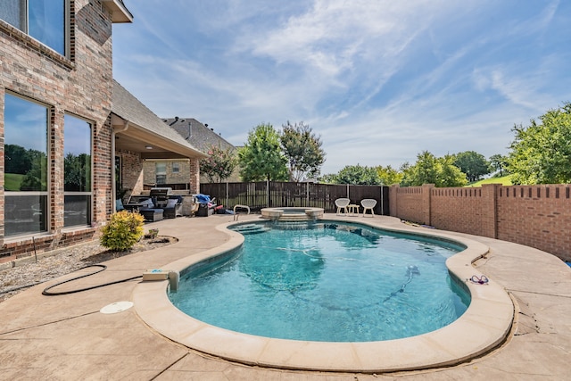 view of swimming pool with an in ground hot tub and a patio