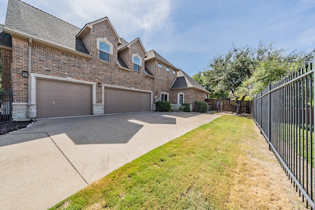 view of front of home with a garage and a front yard