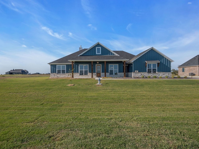611 N Armstrong Rd, Venus, TX 76084 - craftsman-style house with board and batten siding, stone siding, and a front lawn