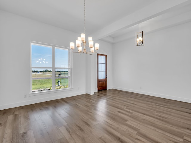 unfurnished dining area with hardwood / wood-style flooring and a notable chandelier