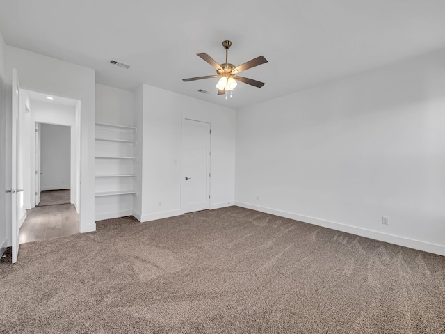 unfurnished bedroom with ceiling fan and carpet