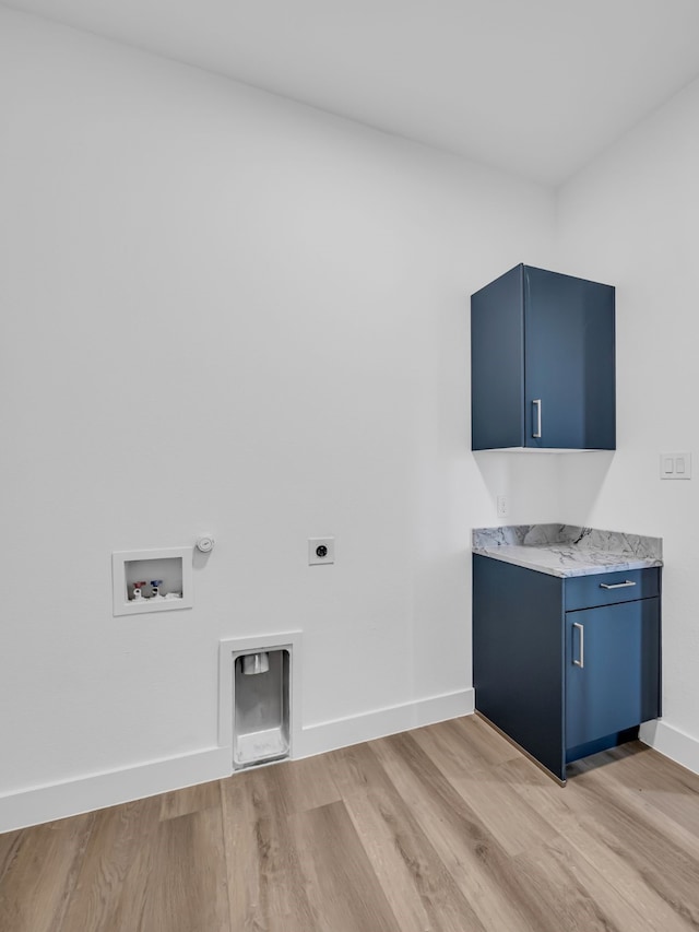 laundry area with cabinets, hookup for a washing machine, hookup for an electric dryer, and light hardwood / wood-style floors