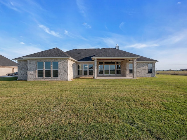 611 N Armstrong Rd, Venus, TX 76084 - rear view of house with a lawn, a shingled roof, and brick siding