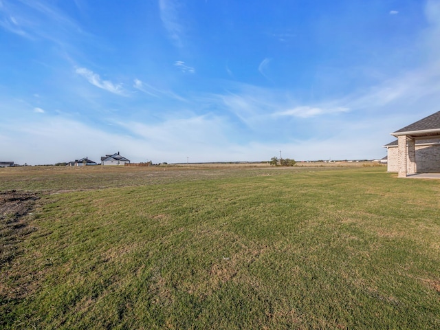 view of yard with a rural view