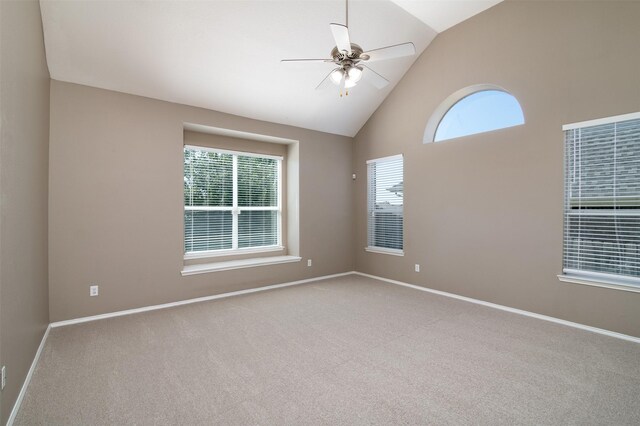 empty room featuring ceiling fan, high vaulted ceiling, and carpet flooring