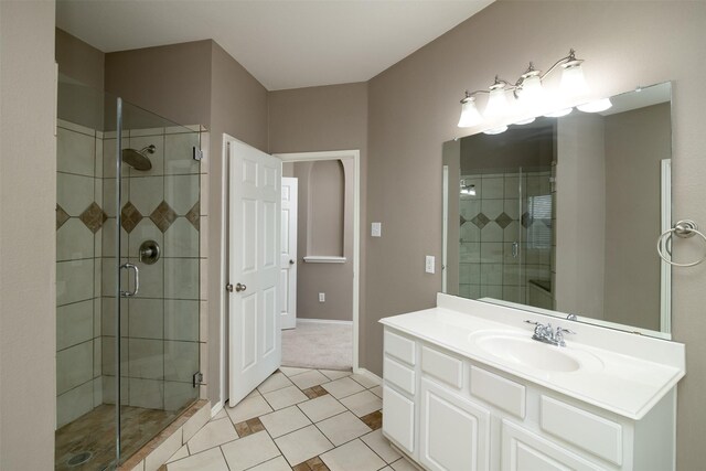 bathroom featuring a shower with door, vanity, and tile patterned flooring