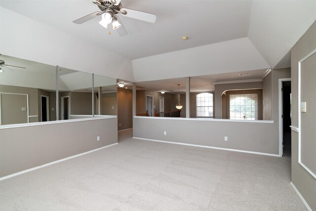 unfurnished room featuring ceiling fan, crown molding, carpet floors, and lofted ceiling