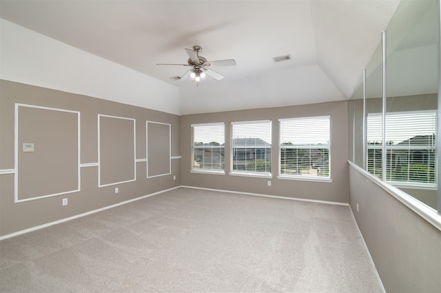 unfurnished room with ceiling fan, vaulted ceiling, and carpet flooring