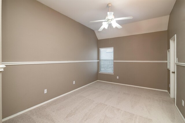 unfurnished room featuring ceiling fan, vaulted ceiling, and carpet flooring