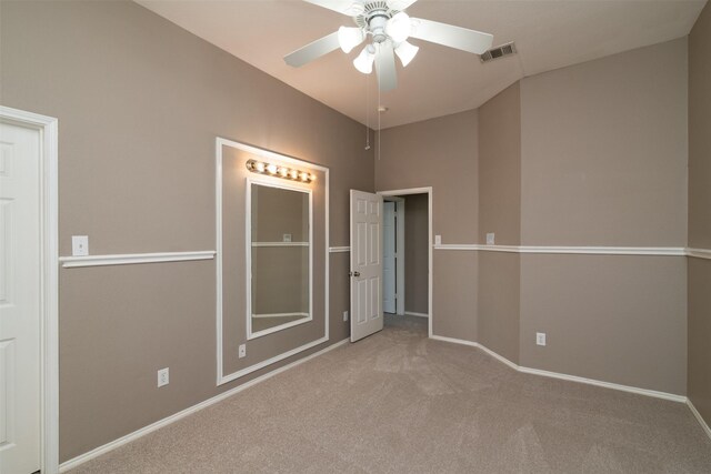 carpeted empty room featuring ceiling fan and lofted ceiling