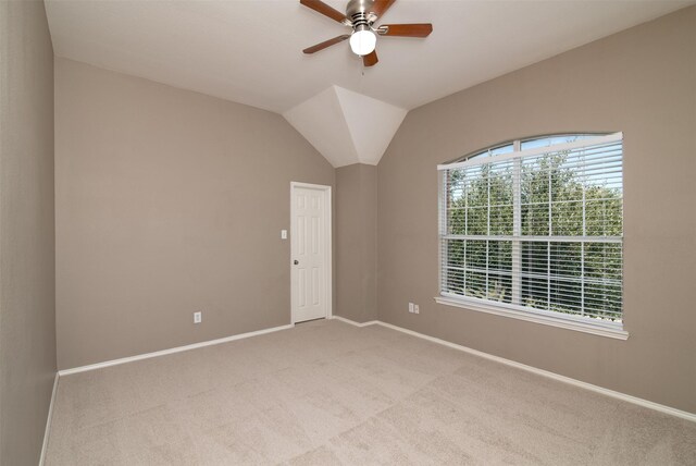 unfurnished room with ceiling fan, vaulted ceiling, and carpet floors