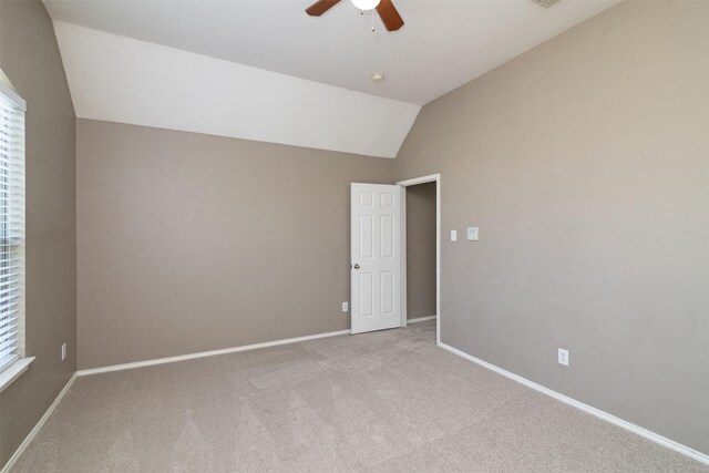 carpeted spare room with lofted ceiling and ceiling fan