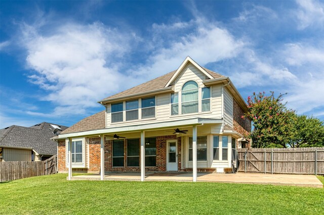 back of property featuring ceiling fan, a lawn, and a patio area