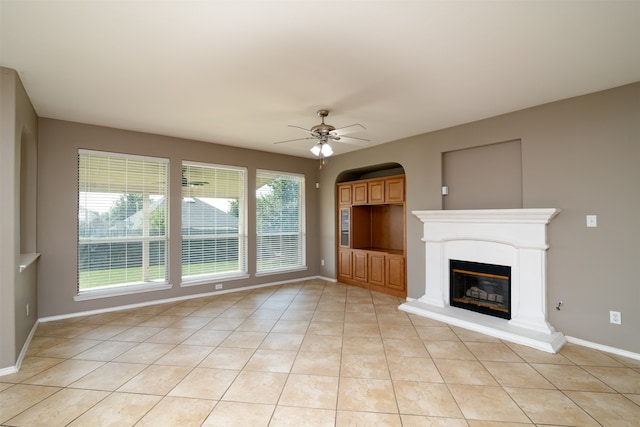 unfurnished living room featuring ceiling fan and light tile patterned floors