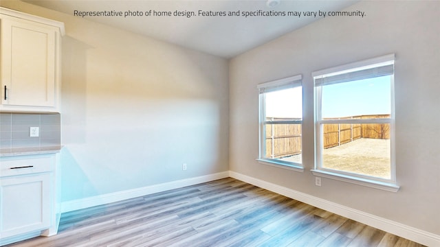 unfurnished dining area featuring light wood-type flooring