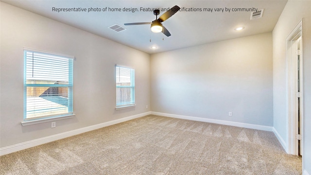 spare room featuring ceiling fan and light colored carpet