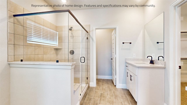 bathroom with a shower with shower door, vanity, and hardwood / wood-style flooring