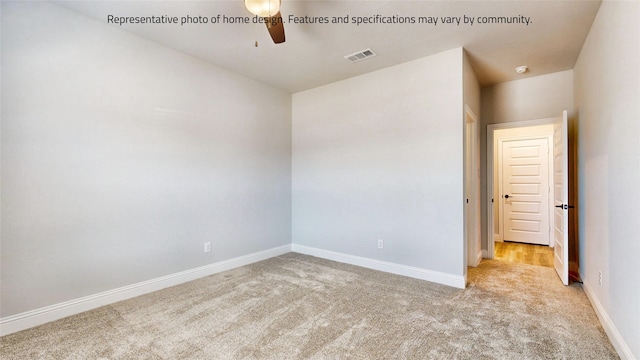 spare room featuring ceiling fan and light colored carpet