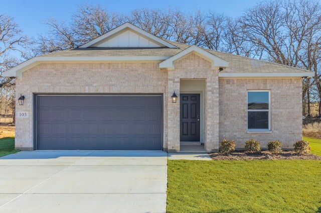 view of front of house with a garage and a front lawn