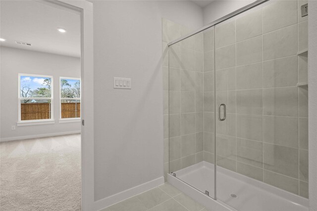 bathroom featuring tile patterned flooring, vanity, and an enclosed shower