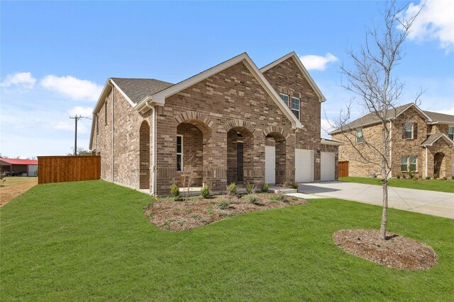 view of front of property with a garage and a front lawn