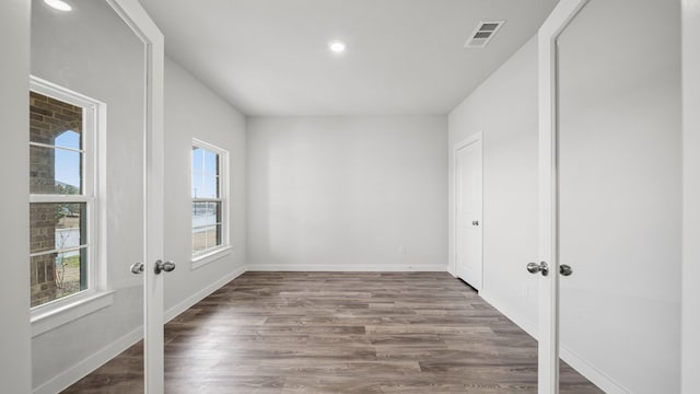 spare room featuring wood-type flooring